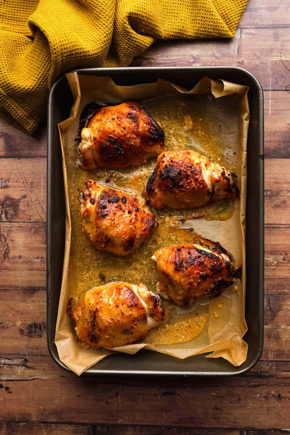 Baked Sweet and Spicy Honey Chicken baked chicken thighs on baking sheet