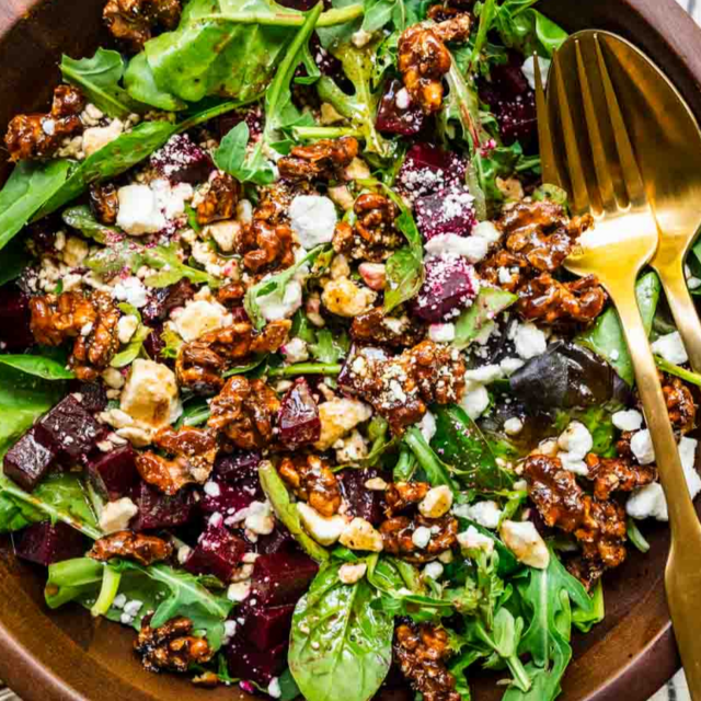 Bowl of greens and ingredients in a wooden bowl