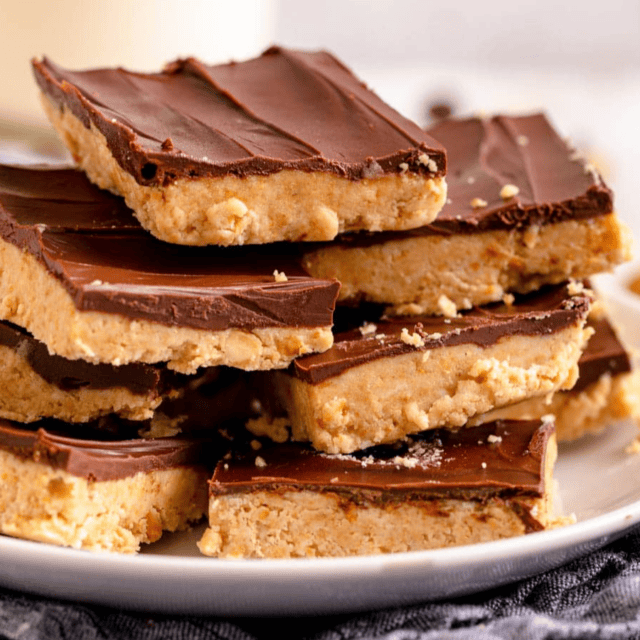 white plate stacked with peanut butter bars