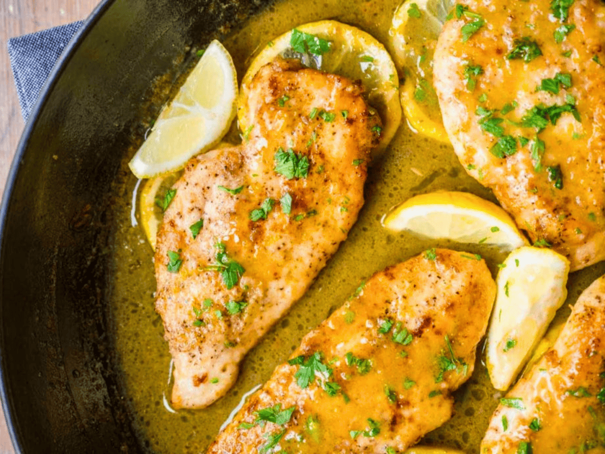Chicken breast in skillet with lemon and herbs