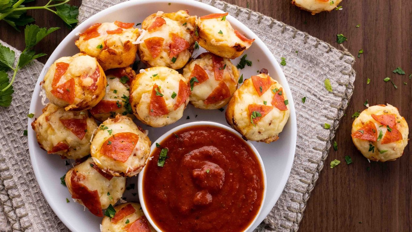 Pepperoni Pizza Bites on serving plate with marinara sauce