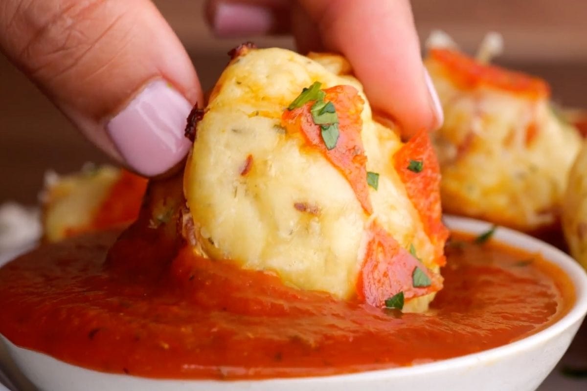 Pepperoni Pizza Bites dipping in sauce