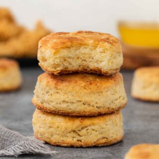 Popeye's Biscuits stack of three biscuits with bite out of top biscuit