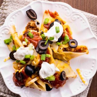 top down view of plated shells with sour cream and olives