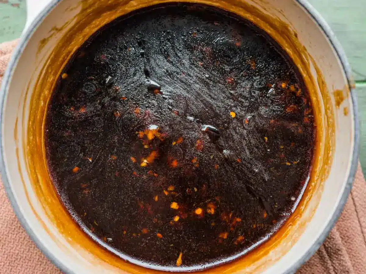 Thickened brown sauce in pan.
