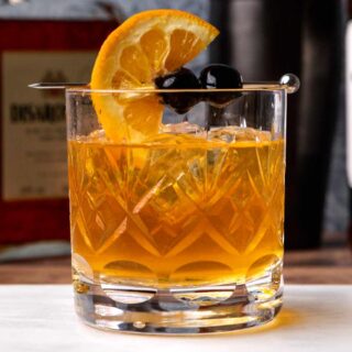Rocks glass with mixed drink and garnish.
