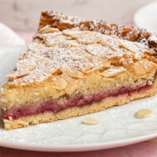 Raspberry almond tart on dessert plate.