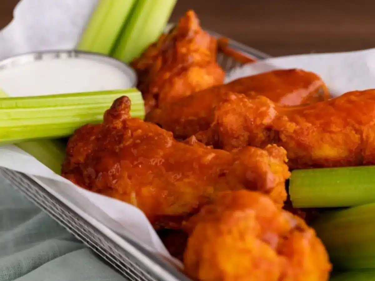 Close up of wings in basket with celery