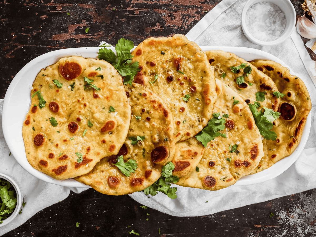 thin circular bread with green garnish on a platter