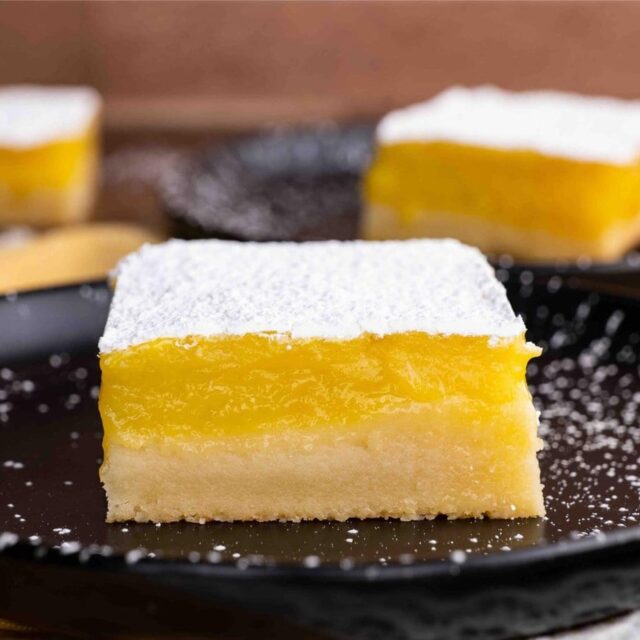 dessert square on plate with powdered sugar topping