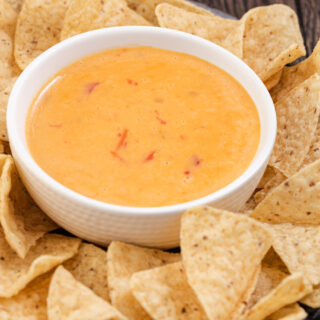 Bowl of melty cheese dip with tortilla chips 4x3