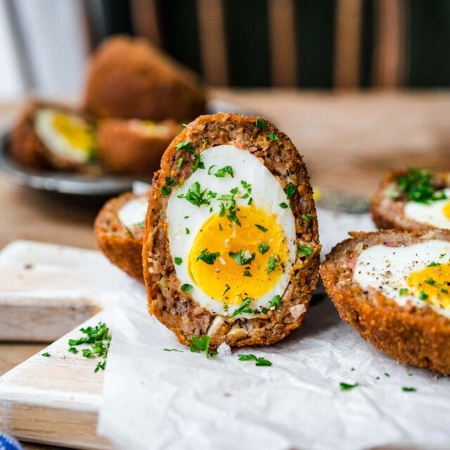 Scotch Eggs finished egg sliced in half vertically and garnished with parsley