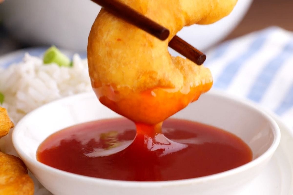 Shrimp Tempura chopstick dipping into sauce