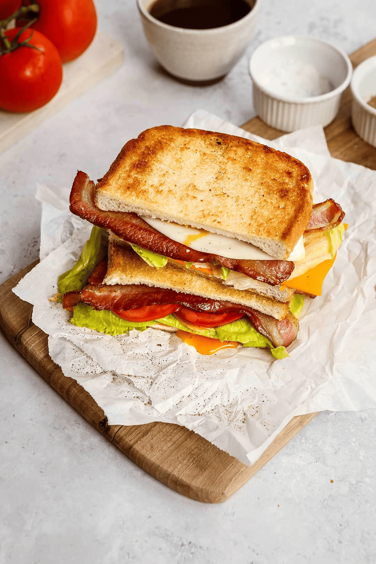 Muti-layer breakfast sandwich on a wood cutting board
