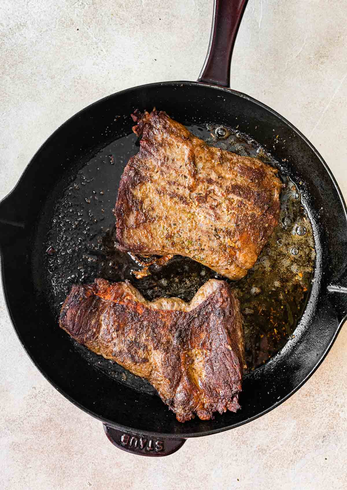 carne asada being cooked on cast iron