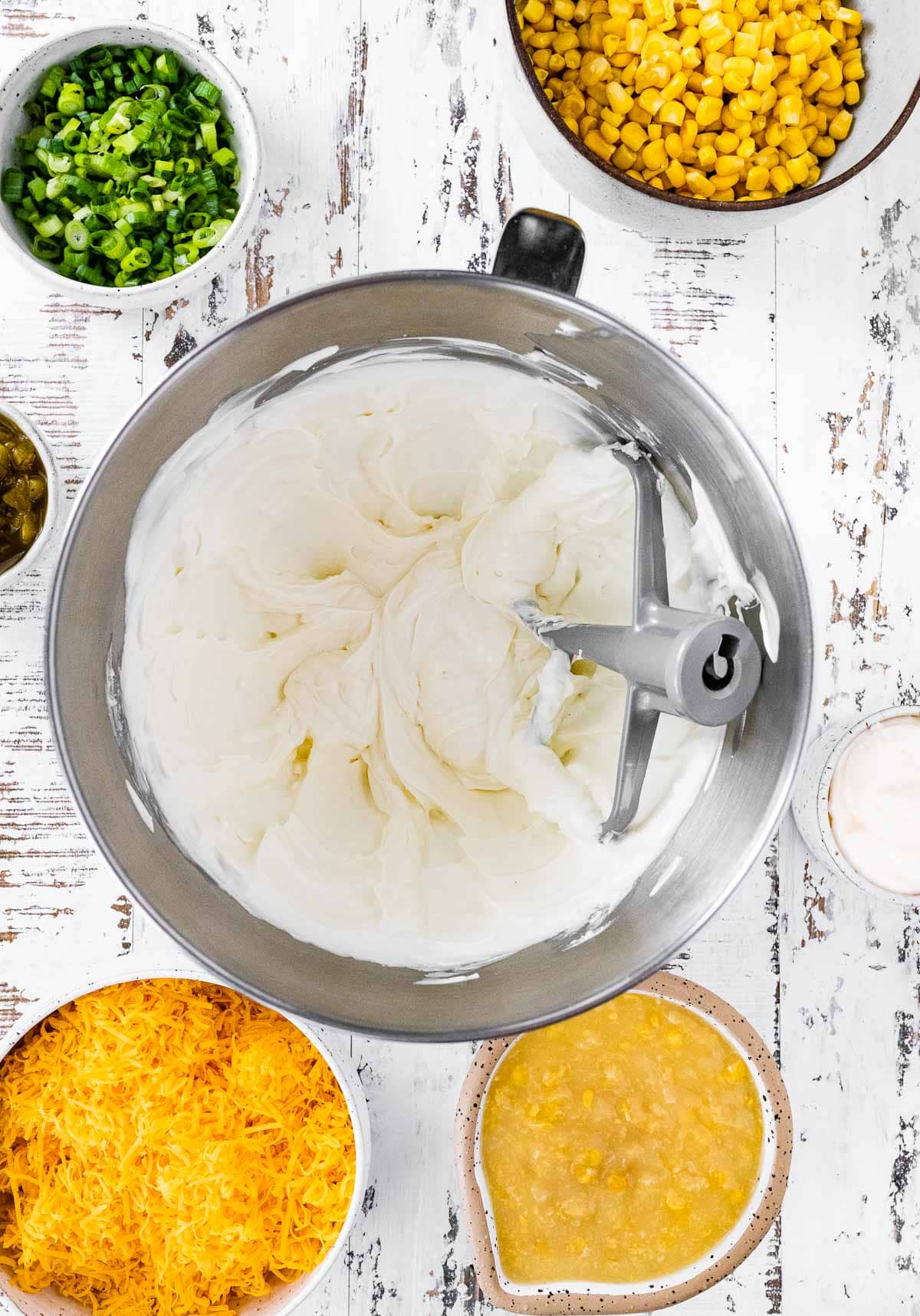 Corn Dip sour cream and cream cheese blended in mixing bowl with paddle attachment