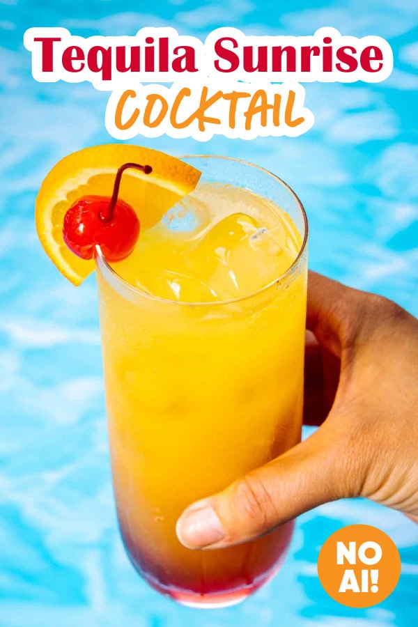Cocktail with orange and cherry garnish.
