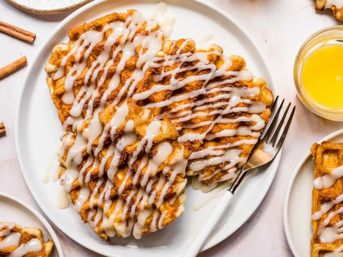 Plate of waffles with drizzle of icing. 
