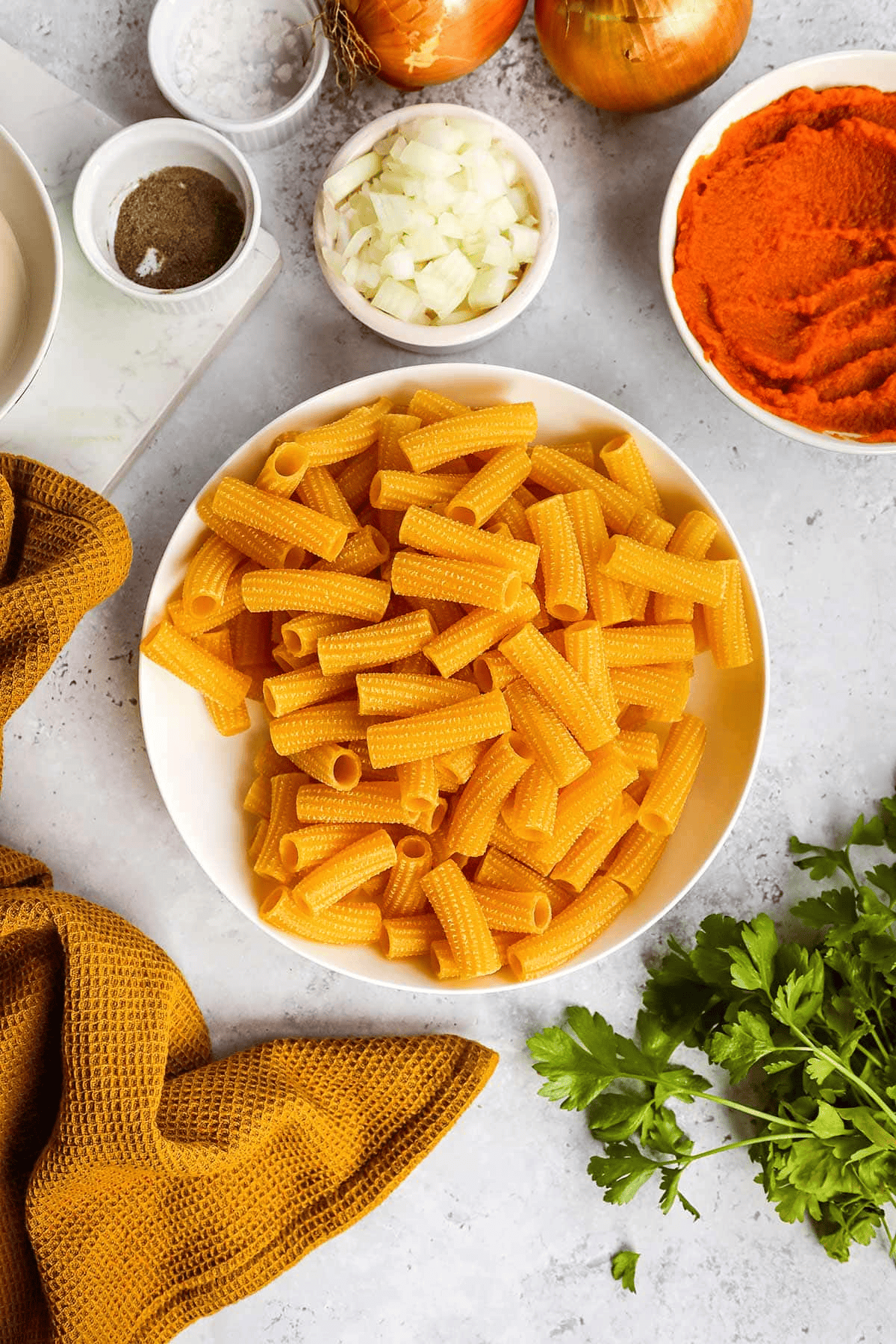 Raw pasta and ingredients in separate bowls