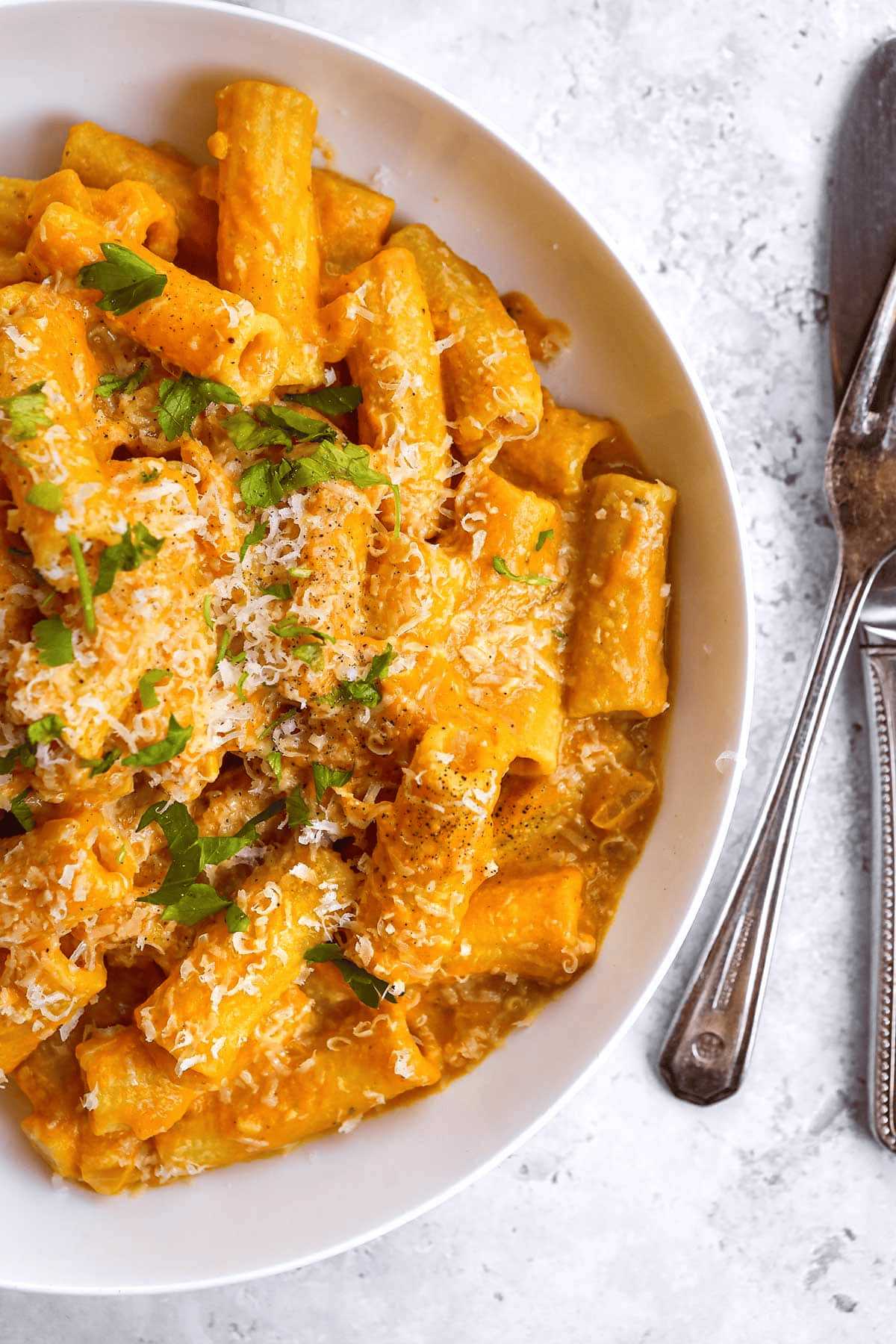 Pasta topped with parmesan and fresh parsley