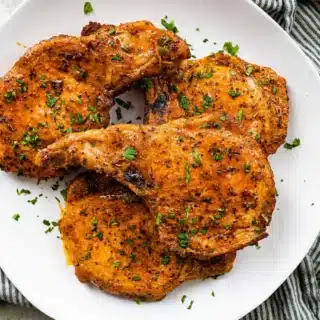 Serving plate with baked and seasoned pork.