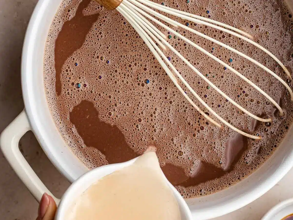 Cocoa and milk heating up in pan.