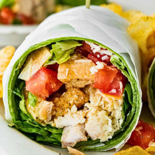 Wrap with tomato, chicken, Parmesan, and Caesar dressing.