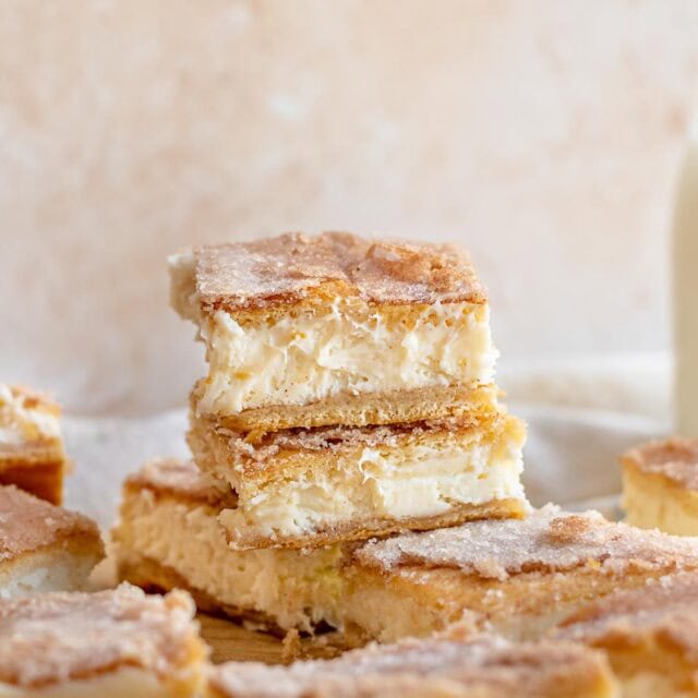 Churro Cheesecake Bars stack of three bars. 4x3 ratio.