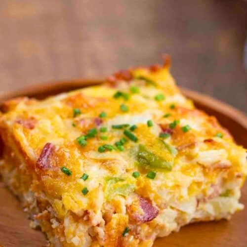 Egg bake cut Into a square served on a wooden plate