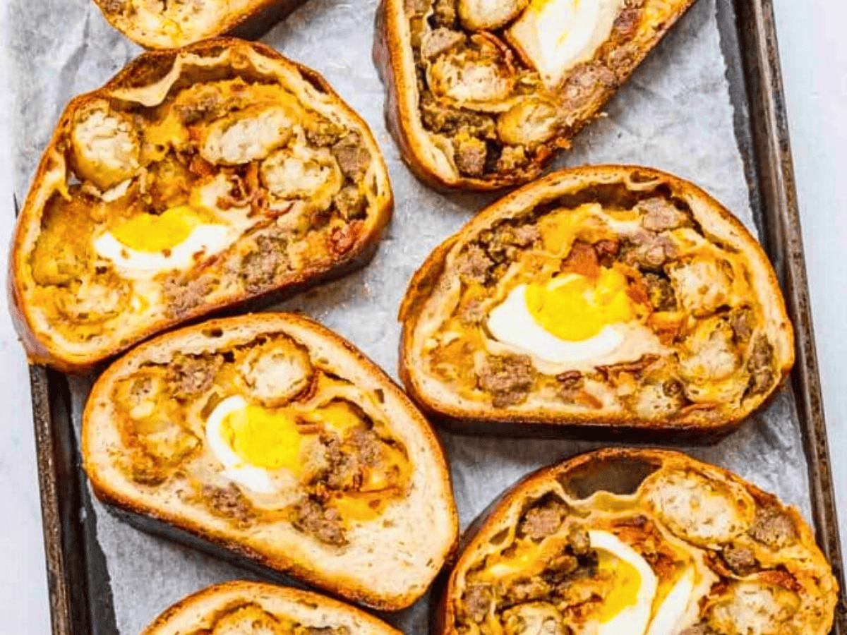 Multiple slices of stuffed bread on baking sheet
