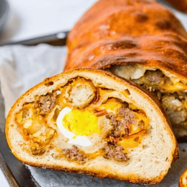 Slice of stuffed bread with loaf behind it