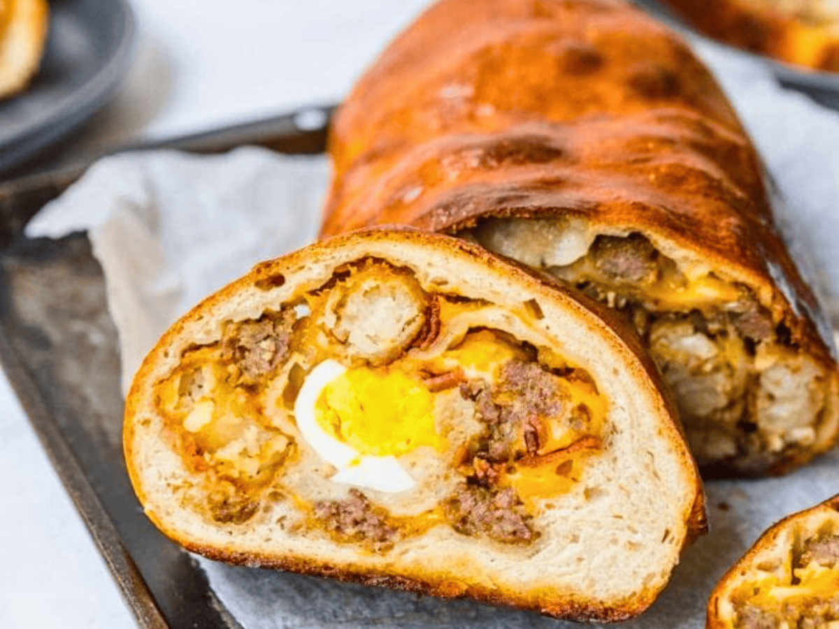 Slice of stuffed bread with loaf behind it