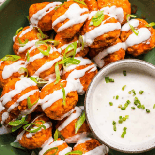 meatballs on a green plate served with dipping sauce