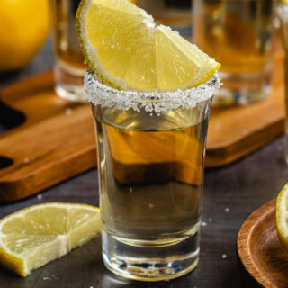 Shot glass with shot, sugared rim, and sugared lemon wedge.