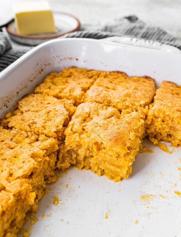 Cornbread Casserole in pan, sliced, close up