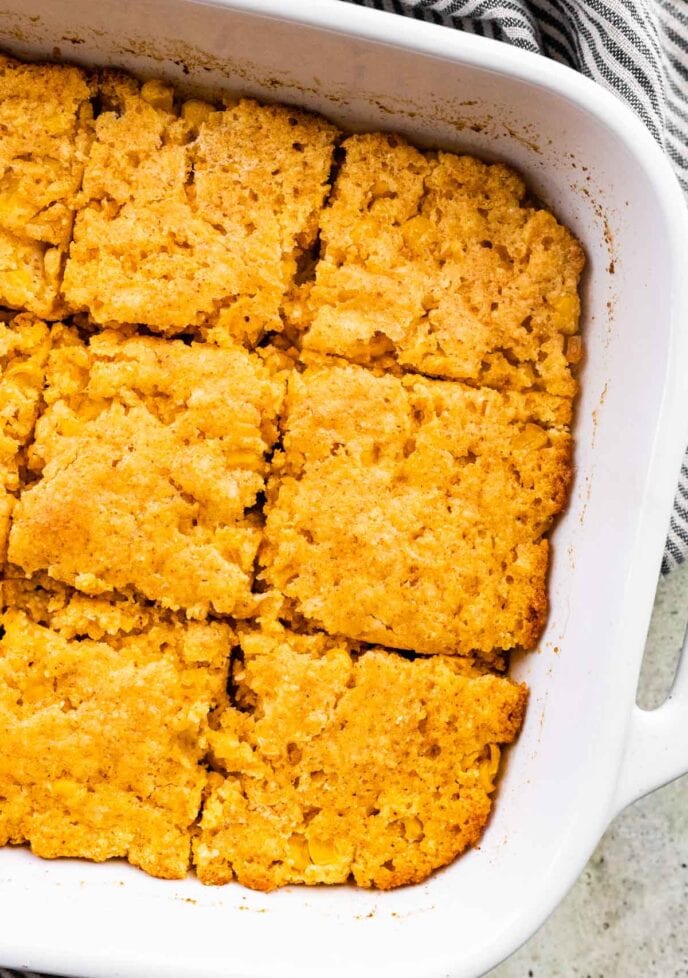 Cornbread Casserole in pan, sliced, close up