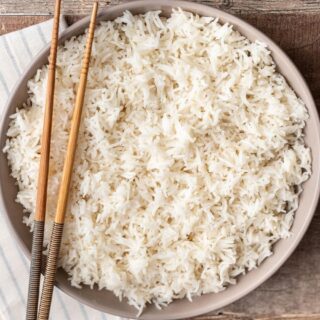 Bowl of rice with chopsticks.