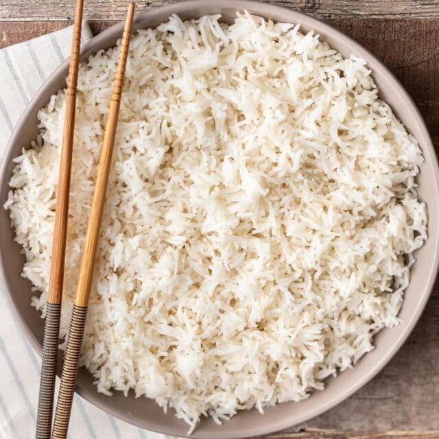 Bowl of rice with chopsticks.