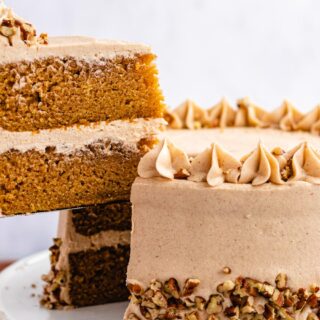 Slice of cake being taken out of whole cake.