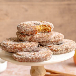 Sugar coated donuts on cake tray.
