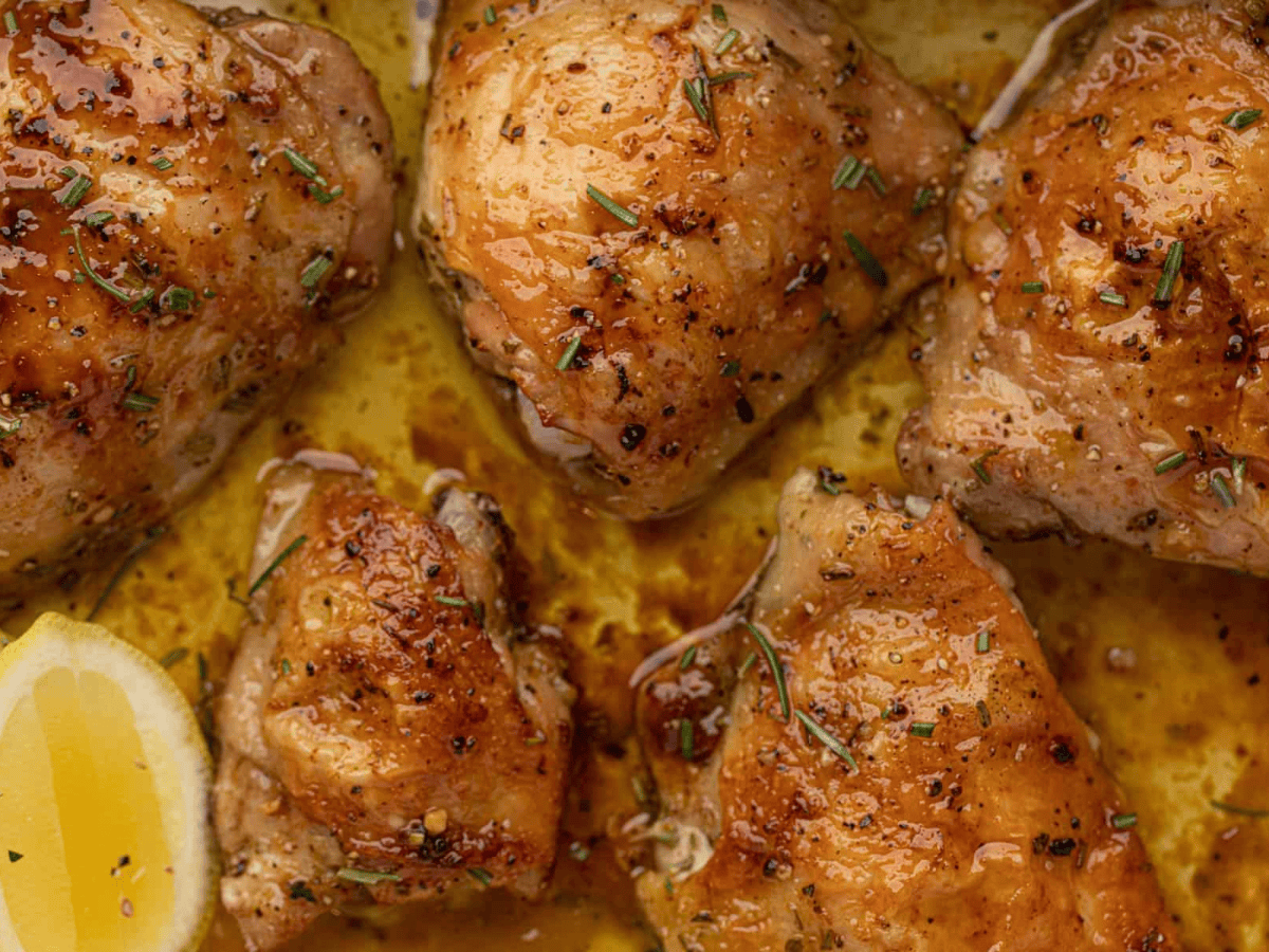 Baked poultry in a baking dish out of the oven with juices