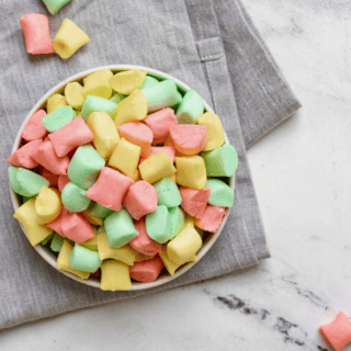 colorful mints in a bowl on table and cloth