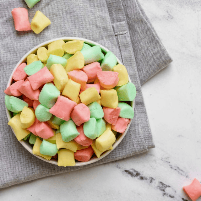 colorful mints in a bowl on table and cloth