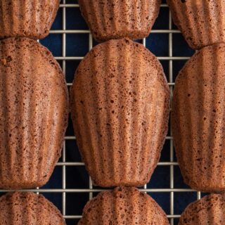 Chocolate Madeleines baked and lined up on baking rack, 1x1