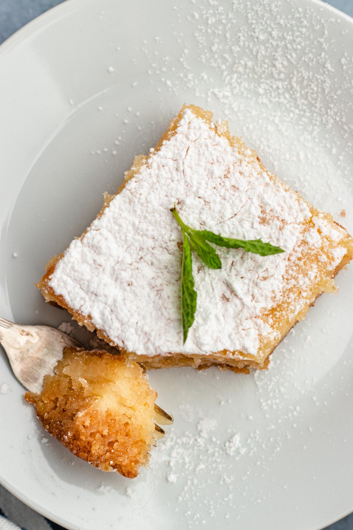 Gooey Butter Cake finished slice on plate with bite on fork