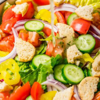 Lettuce salad with tomato, onion, and croutons.