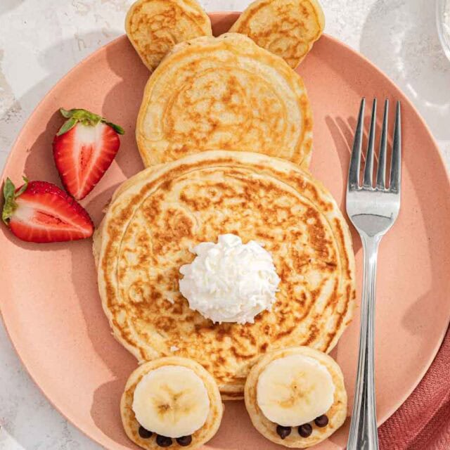 Breakfast plate with griddle cakes in the shape of a bunny.