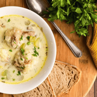 bowl of soup with spoon and bread