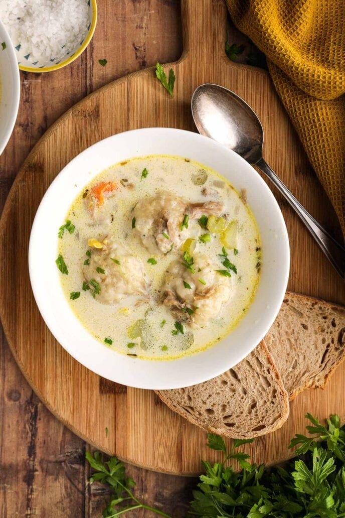 bowl of soup with spoon and bread aerial view