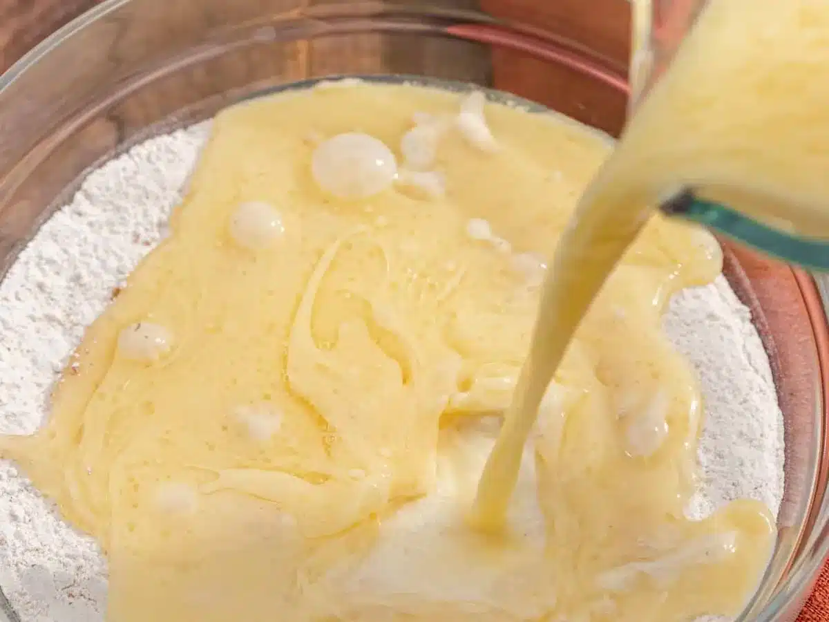 Milk, egg, and oil mixture being added to dry ingredients.